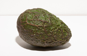 Avocado or alligator pear (Persea americana) on a white background.