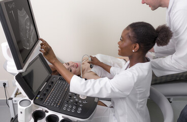 doctors conduct an ultrasound examination of the patient, consulting on the correct diagnosis