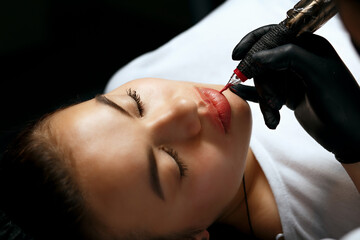 Beautician making lip permanent powder makeup