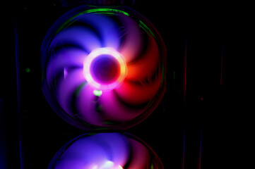 Colorful bright rainbow led rgb pc fan air case cooler. Computer chassis. Gaming modding, technology concept and IT background.