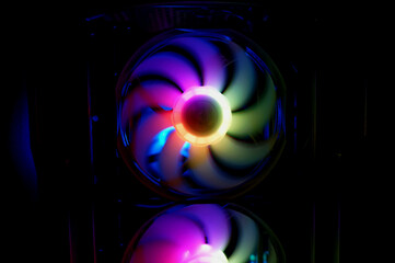 Colorful bright rainbow led rgb pc fan air case cooler. Computer chassis. Gaming modding, technology concept and IT background.