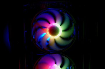 Colorful bright rainbow led rgb pc fan air case cooler. Computer chassis. Gaming modding, technology concept and IT background.