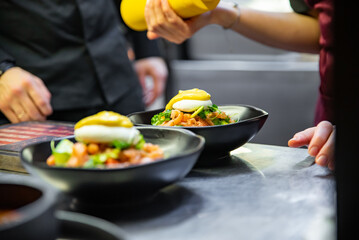 Chef in restaurant kitchen cooking salad 