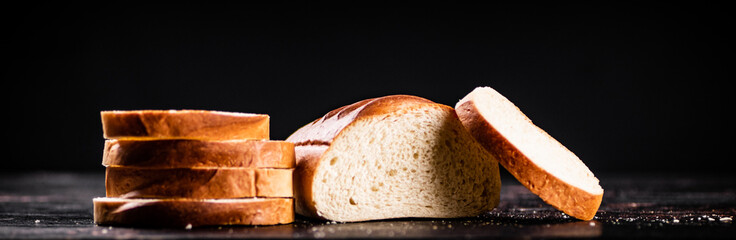 Sliced wheat bread. On a black background.