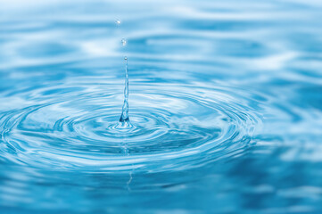 Splash. Rain drops falling on smooth surface of water