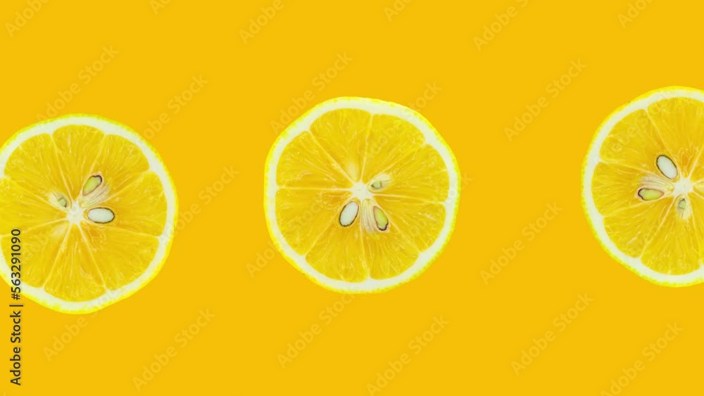 Poster lemon slices rotating on yellow background. stop motion citrus animation. healthy eating and refresh