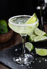 Margarita cocktail with ice, lime and salt rimm