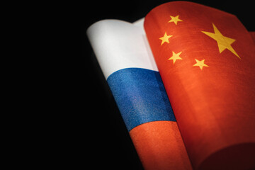 flags of the China and russia on a black background. The concept of interaction or counteraction between the two countries. International relations. political negotiations. copy space. - obrazy, fototapety, plakaty