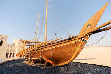 Old wooden rowing boat at historical are of Dubai. Heritage village. Boat installation.