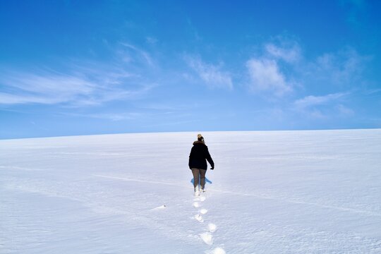 Person Walking On Snow A Track Behind