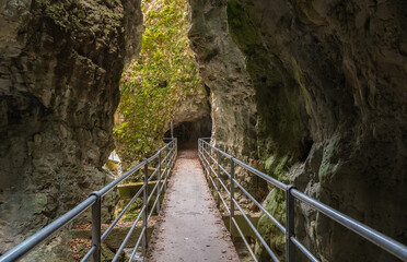Fototapeta na wymiar The Rio Sass di Fondo canyon in Non Valley, Trentino Alto Adige: a scenic excursion among narrow rock walls and fascinating light effects - Fondo, northern Italy .
