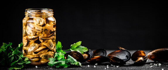 Delicious pickled mussels with parsley on the table. 