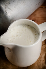 A jug of fresh milk on the table. 