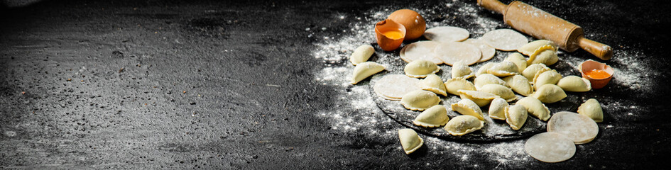 Fototapeta na wymiar Raw potato dumplings with eggs and flour on a stone board. 