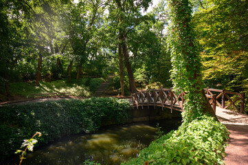 Beautiful wooden vintage bridge across the river in autumn in Sofia park, Uman, Ukraine.