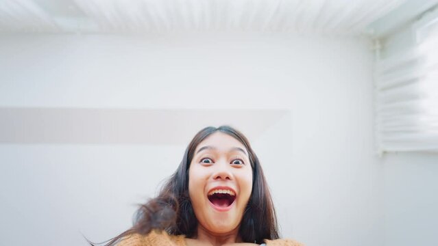 Surprise excited asian woman opening gift box, Inside view of carton box bottom, Satisfied client, positive feedback. Delivery and online shopping concept.