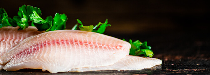 Raw fish fillet with parsley.