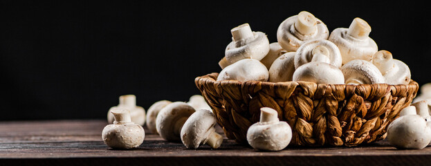 A full basket of mushrooms on the table. 