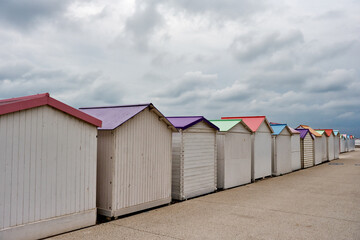 Row of pastel colored bathing huts at Le Treport beach, Normandy, France	
