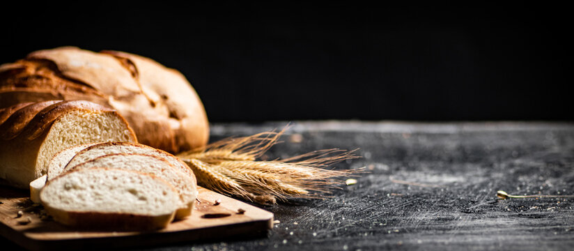 Sliced fresh wheat bread on a cutting board. 