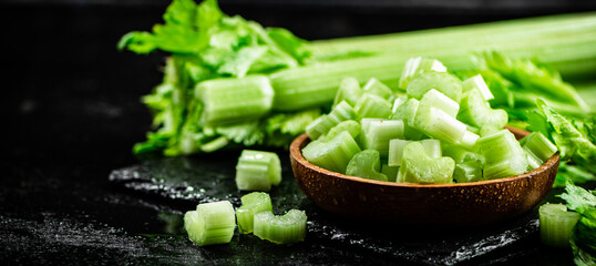 Pieces of fresh celery in a wooden plate. 