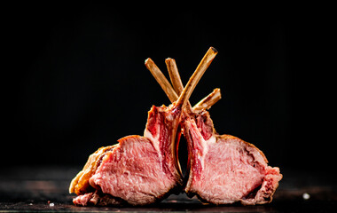 A delicious rack of grilled lamb on the table. 