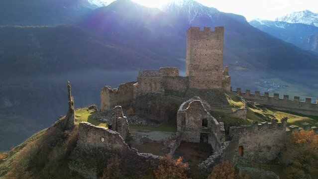 Medieval impressive castle Cly surrouded by Alps mountains in Valle d'aosta, aerial drone view
