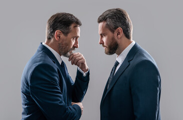 confrontation of two businessmen in suit. photo of businessmen has confrontation look