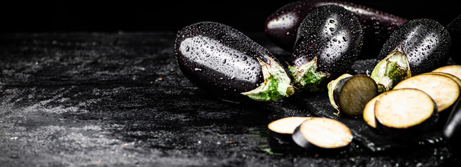 Pieces of ripe eggplant on a stone board. 