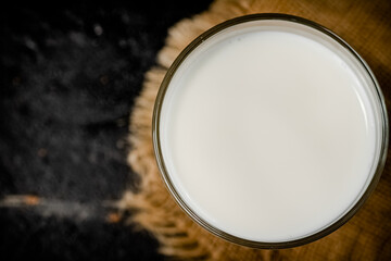 A full glass of fresh milk on a napkin. 