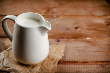 A jug of fresh milk on the table. 