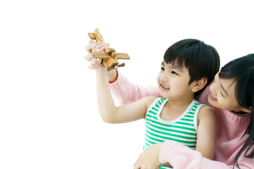 Happy Asian little young boy playing a wooden airplane toy with his motherใ