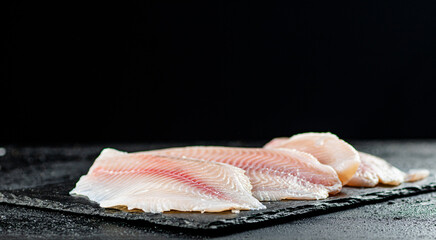 Uncooked fish fillet on the table. 