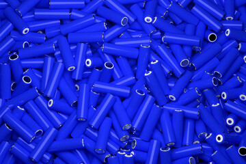 Top view full frame background of many 18650 lithium blue batteries chaotically arranged.