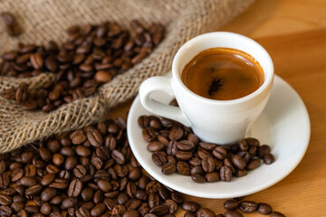 a mug of invigorating espresso in coffee beans