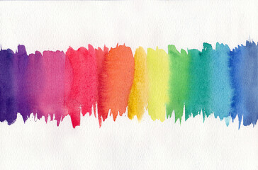 palette of different primary colors of watercolor paints on a white background.