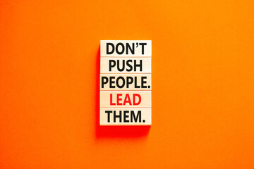 Push or lead people symbol. Concept words Do not push people lead them on wooden blocks. Beautiful orange table orange background. Business Push or lead people concept. Copy space.