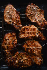 Pieces of fried pork meat. Barbecue. Delicious fried pork loin. Chunks of meat in close-up. Meat on coals.