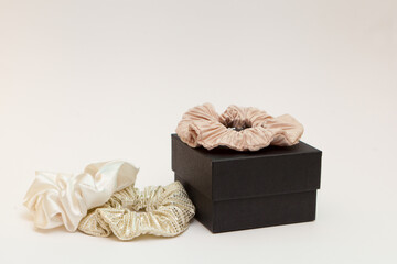 Obraz premium gift box with beige silk scrunchies. lot or hair ties. Luxury tools for ladies. perfect for all hair