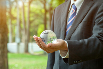 businessman holding a glass globe