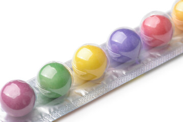 Closeup of colorful chewing gum balls in stick pack