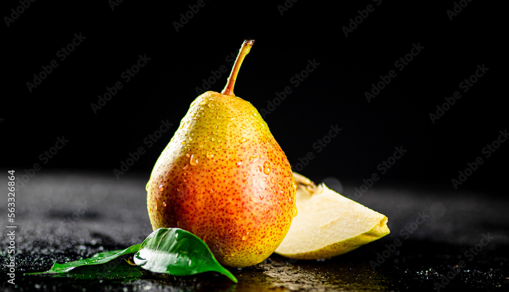 Poster Ripe pear on a table with leaves. 