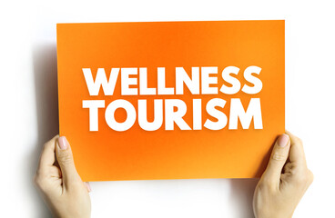 Wellness tourism - travel for the purpose of promoting health and well-being through physical, psychological, or spiritual activities, text on card concept
