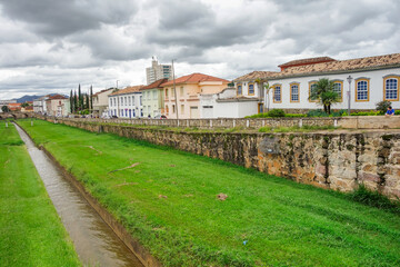 Fototapeta na wymiar narrow stream, old bridge and ancient architecture of Sao Joao del Rei, Minas Gerais state, Brazil