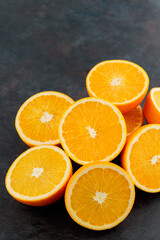 Fresh orange halves on a dark background. Juicy citrus fruits for making juice