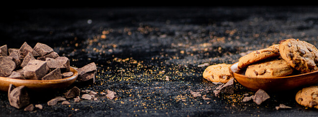 Wooden plate with cookies and pieces of milk chocolate. 