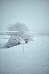 A utility pole and wires are covered with ice. Power outage during a winter snowstorm.