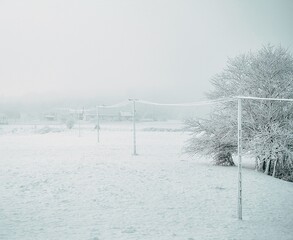 Local electric pole covered with ice and snow. Concept of electricty and blackouts problem during winter snowstroms in rural areas.