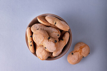 cookies in the shape of eights, with blueberries, on a round plate on a blue background, a place to copy