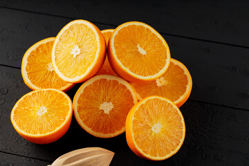 Fresh ripe oranges on a dark wooden table. Fresh citrus fruits for vegetarian dishes